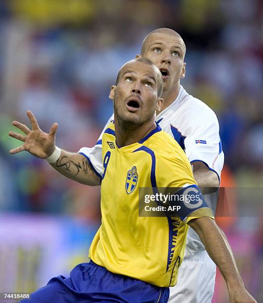 Sweden's Fredrik Ljungberg and Iceland's Gretar Steinsson eye the ball during their Euro 2008 Group F qualifying football match at Solna's Rasunda...