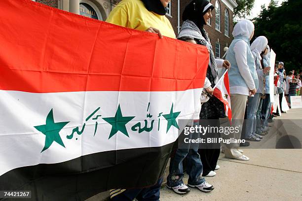 Arab Americans join hands to form a human chain as a sign of Arabic unity during a rally in front of Dearborn City Hall June 6, 2007 in Dearborn,...