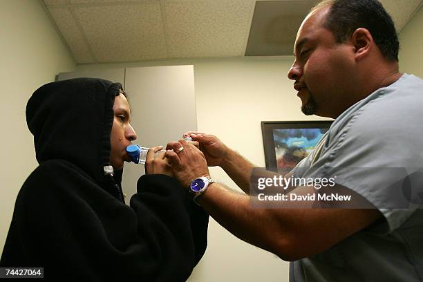 Alex Rider Inhaler Asthma program director Alex Aldrete teaches 15-year-old Jesus Ayala ...