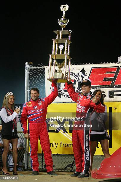 Tony Stewart hands Carl Edwards the trophy for winning the Nextel Prelude to the Dream on June 6, 2007 at Eldora Speedway in New Weston, Ohio.