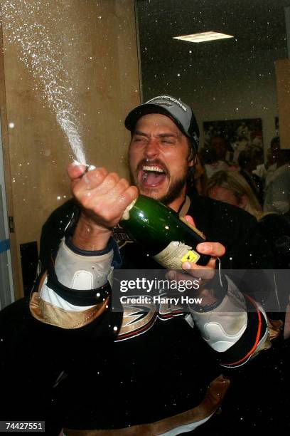Teemu Selanne of the Anaheim Ducks sprays champagne in the locker room after his team's victory over the Ottawa Senators 6-2 during Game Five of the...