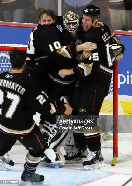 Ryan Getzlaf, Corey Perry and goaltender Jean-Sebastien Giguere of the Anaheim Ducks celebrate after defeating the Ottawa Senators in Game Five of...