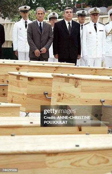 French Toulon's Mayor Hubert Falco and prefect Pierre Dartout pay their respect in front of the coffins 07 June 2007 in Toulon, during the ecumenical...