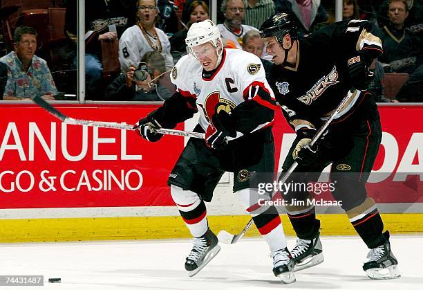 Daniel Alfredsson of the Ottawa Senators is challenged by Ryan Getzlaf of the Anaheim Ducks during the third period of Game Five of the 2007 Stanley...