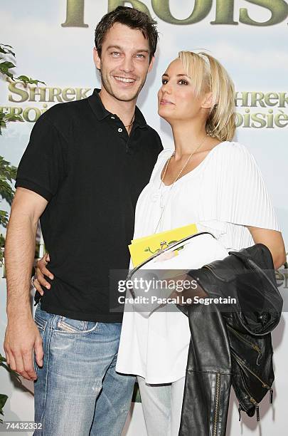 Bertrand Lacherie and Elodie Gossuin pose as they arrive to attend the premiere of Chris Miller's film "Shrek 3" on June 7, 2007 in Paris, France.