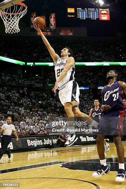 Manu Ginobili of the San Antonio Spurs lays the ball up over LeBron James of the Cleveland Cavaliers in Game One of the 2007 NBA Finals on June 7,...