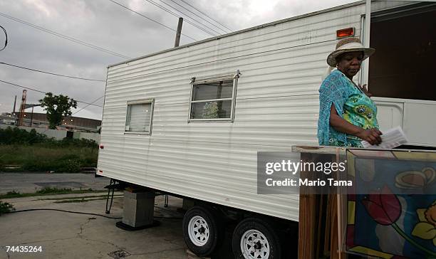 Vanessa Gaten stands on the front steps of her FEMA trailer with the Superdome in the background June 7, 2007 in New Orleans, Louisiana. Gaten says...