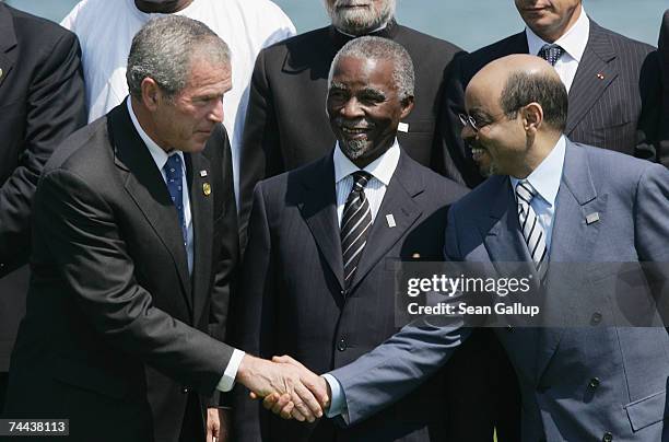 President George W. Bush greets Ethiopian Prime Minister Meles Zenawi as South African President Thabo Mbeki at a group photo opportunity at the...