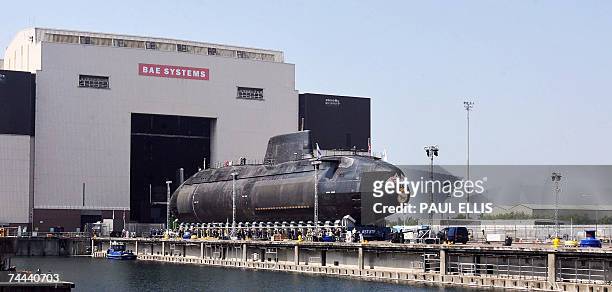 Barrow in Furness, UNITED KINGDOM: The first Astute class nuclear submarine is brought out of the Devonshire Dock Hall at the BAE Systems production...