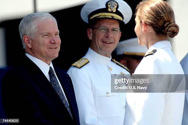 In this handout provided by the US Navy, Secretary of Defense the Honorable Dr. Robert M. Gates congratulates a newly commissioned Ens., after she...