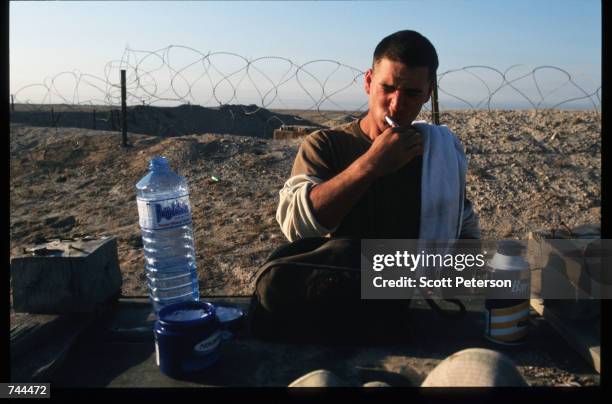 Marine brushes his teeth at a makeshift vanity December 20, 1996 in Kuwait. As part of the Defense Cooperation Agreement signed by the two nations,...