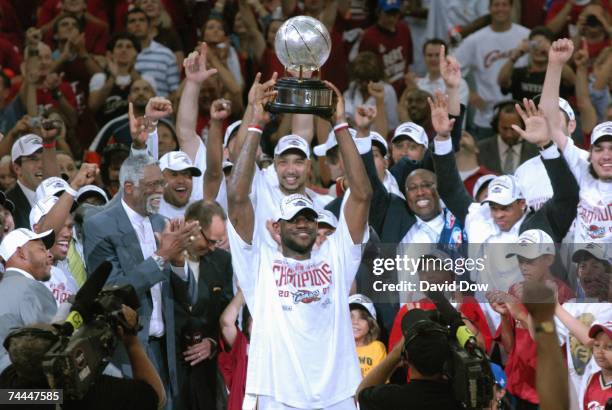 LeBron James of the Cleveland Cavaliers holds the Eastern Conference Championship trophy after defeating the Detroit Pistons in Game Six of the...