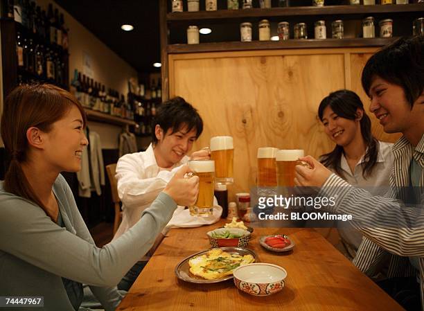 japanese people drink a toast in izakaya with smiling - サラリーマン 酒 ストックフォトと画像
