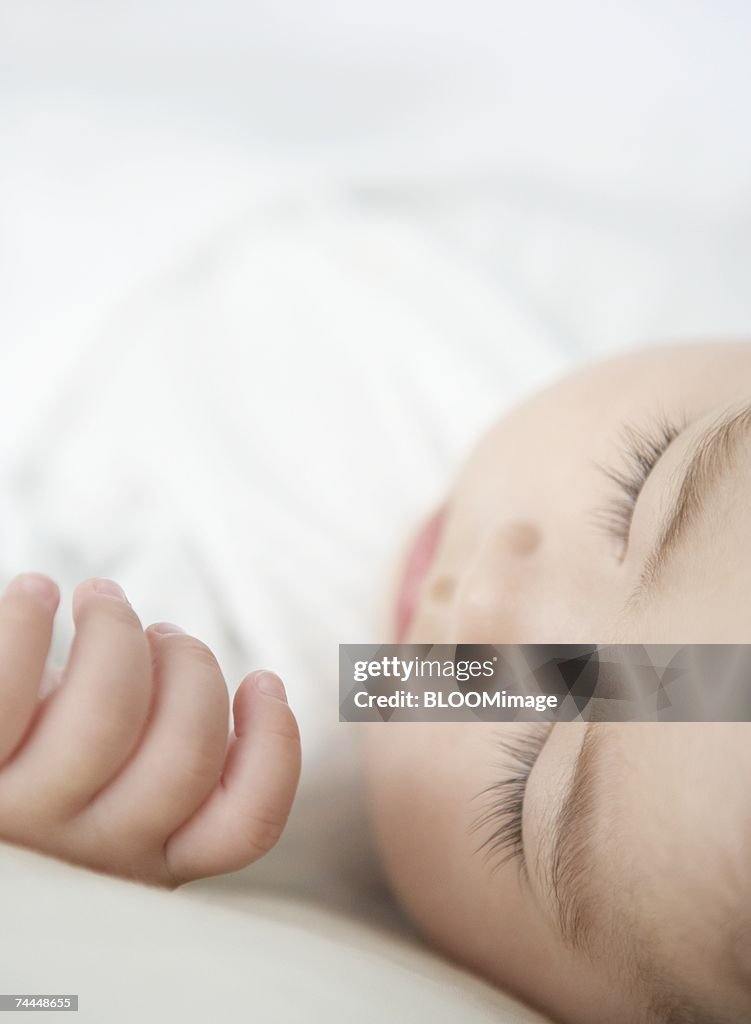 Japanese baby's hand sleeping on bed ,close-up