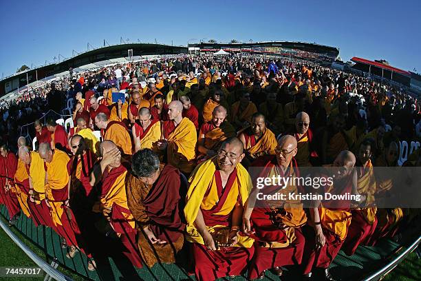 Buddhist Monks look on during the Dalai Lama's free public talk about Universal Responsibility at MC Labour Park June 9, 2007 in Melbourne,...
