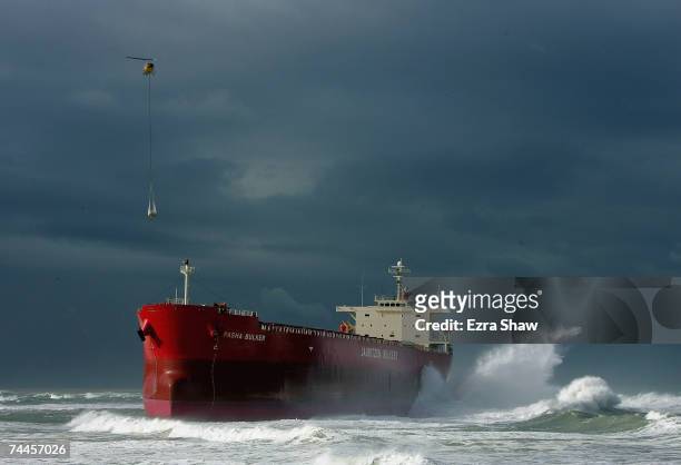 Helicopter drops supplies to the salvage crew on the coal ship the Pasha Bulker to asses the damage as it sits off Nobbys Beach June 9, 2007 in...