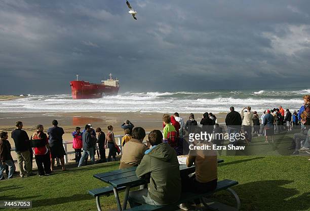 People watch the rescue efforts of the coal ship, the Pasha Bulker as it sits off Nobbys Beach June 9, 2007 in Newcastle, Australia. The 225-metre...
