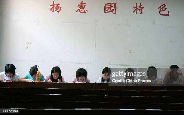 Students wait to attend a spoken English test, part of the National College Entrance Examination, at the University of International Business and...