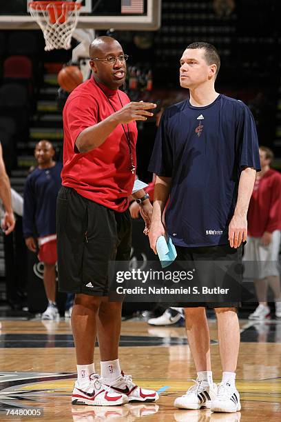 Head coach MIke Brown and assistant coach Michael Malone of the Cleveland Cavliers talk during practice on an off day between Games 1 and 2 of the...