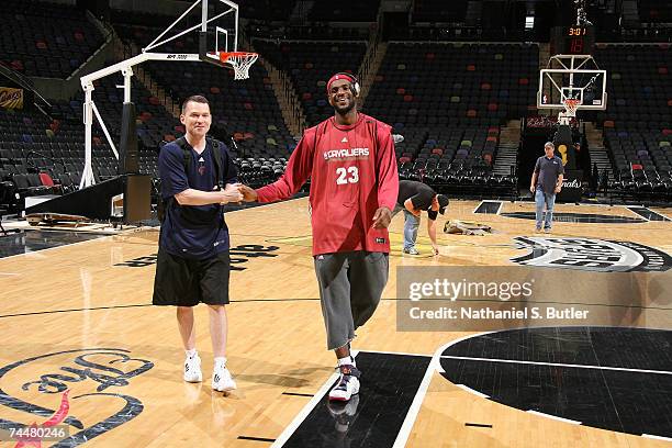 Assistand coach Michael Malone and LeBron James of the Cleveland Cavliers walk off the court after practice on an off day between Games 1 and 2 of...