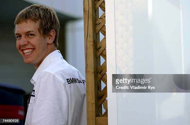Sebastian Vettel of Germany and BMW Sauber smiles in the paddock after qualifying for the Canadian Formula One Grand Prix at the Circuit Gilles...