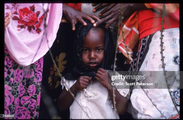 Child stands in line at a food distribution site June 20, 1993 in Mogadishu, Somalia. An estimated 350,000 Somalis died due to war, famine and...