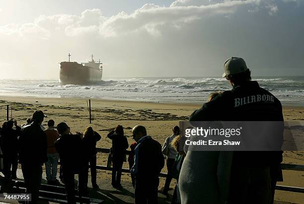 Spectators line the shores to look at the coal ship Pasha Bulker, which sits off Nobbys Beach June 10, 2007 in Newcastle, Australia. The 225-metre...