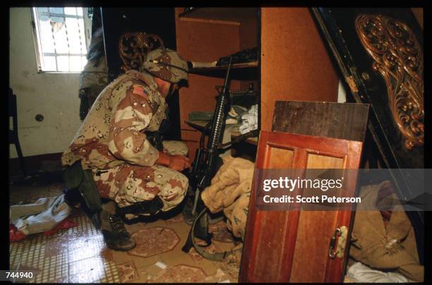 United Nations soldier searches a cabinet June 6, 1993 in Mogadishu, Somalia. UN troops seized the residence of General Mohammad Aidid, a warlord...