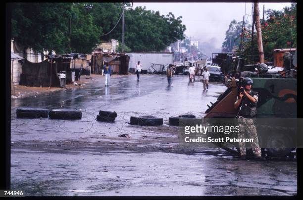 United Nations soldier stands next to an armored personal carrier June 6, 1993 in Mogadishu, Somalia. UN troops seized the residence of General...