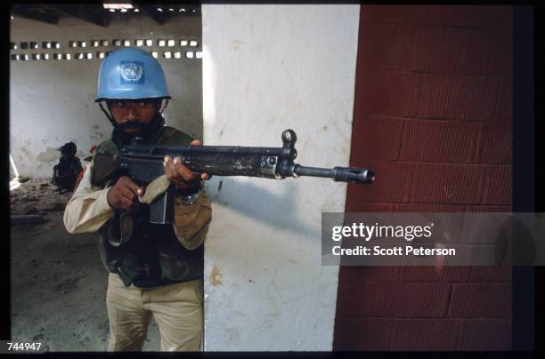 United Nations soldier aims his gun June 6, 1993 in Mogadishu, Somalia. UN troops seized the residence of General Mohammad Aidid, a warlord...