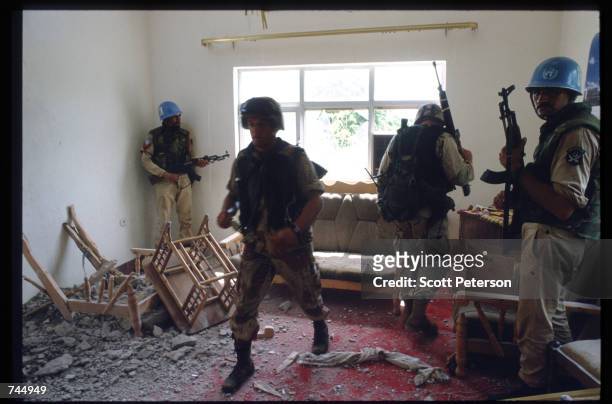 United Nations soldiers search through debris June 6, 1993 in Mogadishu, Somalia. UN troops seized the residence of General Mohammad Aidid, a warlord...