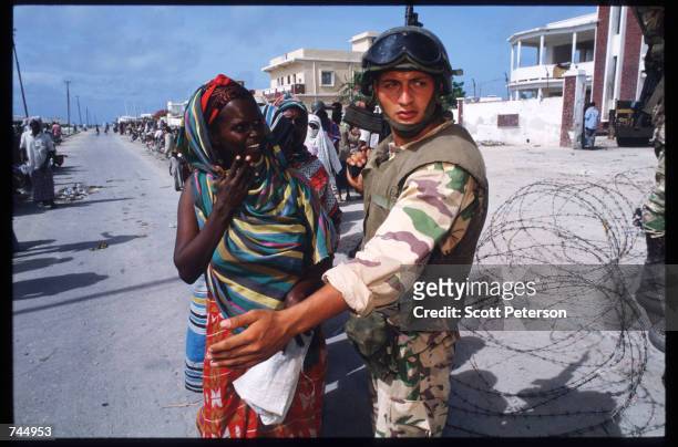 Somali woman speaks to a United Nations soldier June 6, 1993 in Mogadishu, Somalia. UN troops seized the residence of General Mohammad Aidid, a...