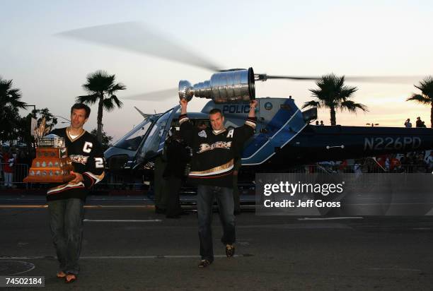 The Stanley Cup is delivered to the Honda Center in a helicopter by Rob Niedermayer and the Conn Smythe Trophy by Scott Niedermayer during the...