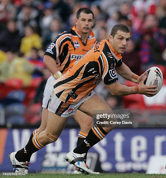 Robbie Farah of the Tigers runs the ball during the round 13 NRL match between the Newcastle Knights and the Wests Tigers at EnergyAustralia Stadium...