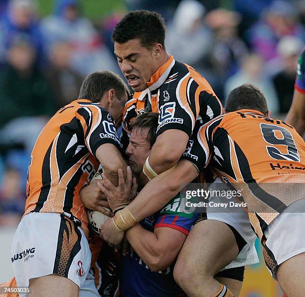 Shannon McDonnell of the Knights is group tackled by Tigers defence during the round 13 NRL match between the Newcastle Knights and the Wests Tigers...