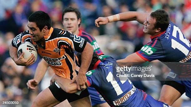 Dean Halatau of the Tigers is tackled by the Knights defence during the round 13 NRL match between the Newcastle Knights and the Wests Tigers at...
