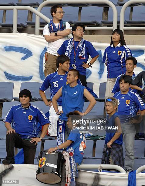 Japanese supporters of the country's women's football team look disappointed after their team's draw with South Korea in a women's qualifying...