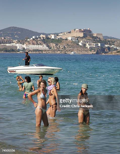 Eivissa Old Town is seen in the distance as people enjoy Playa D'En Bossa Beach on June 7, 2007 in Spain Ibiza.Ibiza remains one of the world's top...