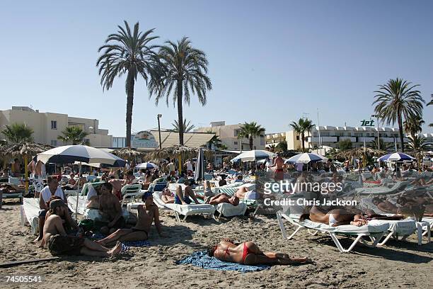 People relax on the beach in front of Bora Bora Beach bar on Playa D'En Bossa Beach on June 7, 2007 in Spain Ibiza. Ibiza remains one of the world's...