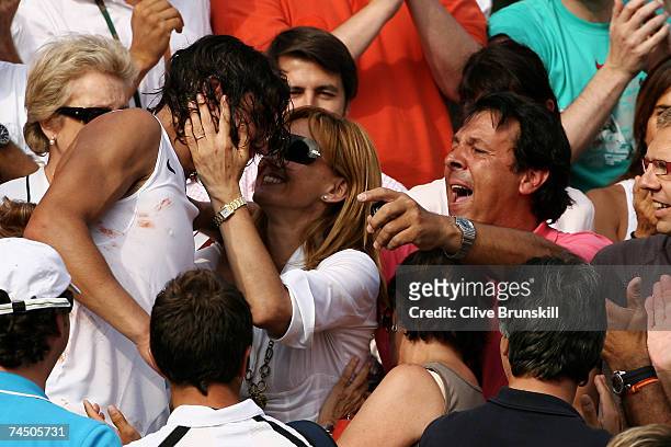 Rafael Nadal of Spain runs to the stands to see his family after winning match point against Roger Federer of Switzerland during the Men's Singles...