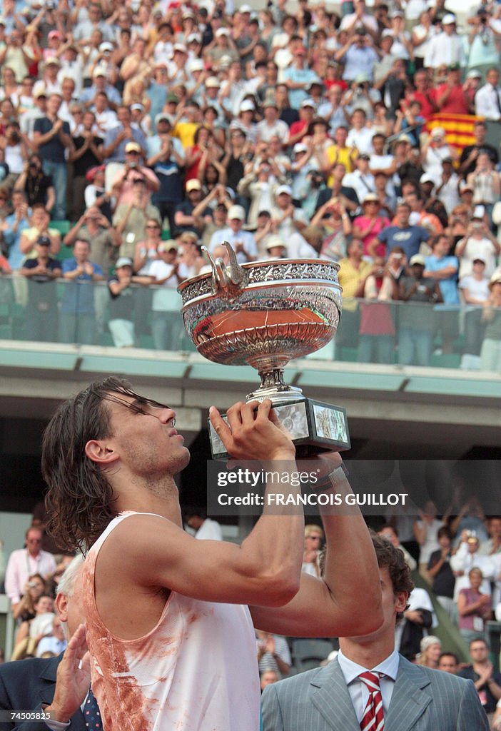Spanish player Rafael Nadal holds his tr...