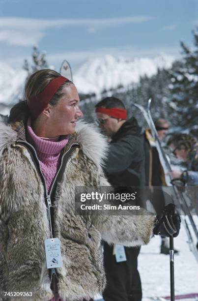 Woman wearing a fur coat and holding ski poles in Vail, Colorado, USA, 1964.