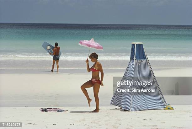 Couple relax at the beach on Harbour Island, Bahamas, 1967.