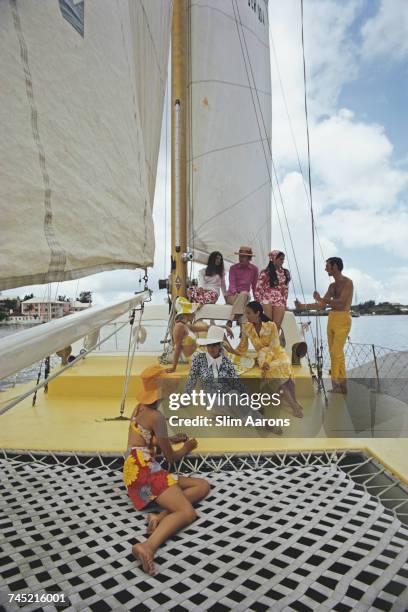 Group of colourfully dressed friends on board the Calypso clothing store owned boat, Bermuda, June 1970.