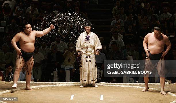 Honolulu, UNITED STATES: Grand champion, or yokozuna, Hakuho of Mongolia and fellow yokozuna Asashoryu , also of Mongolia step into the ring to face...