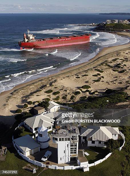 The 30,000-tonne bulk coal carrier 'Pasha Bulker' lies below Nobbys Lighthouse after running aground during severe storms off Nobbys Beach in...
