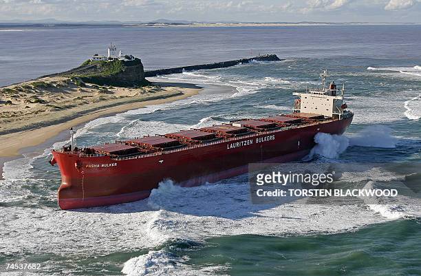 The 30,000-tonne bulk coal carrier 'Pasha Bulker' lies below Nobbys Lighthouse after running aground during severe storms off Nobbys Beach in...