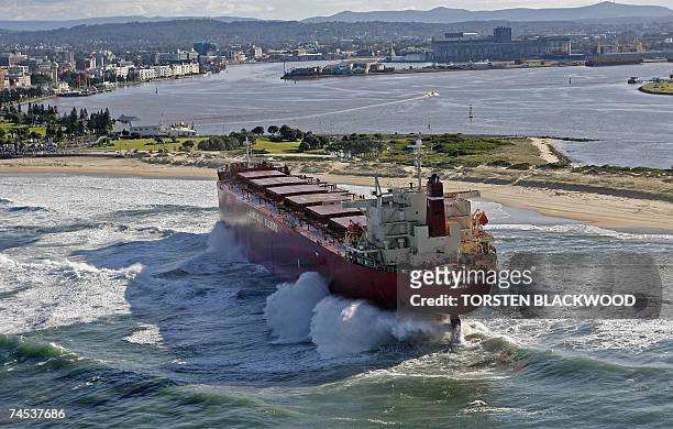 The 30,000-tonne bulk coal carrier 'Pasha Bulker' is pounded by waves after running aground during severe storms off Nobbys Beach in Newcastle, north...
