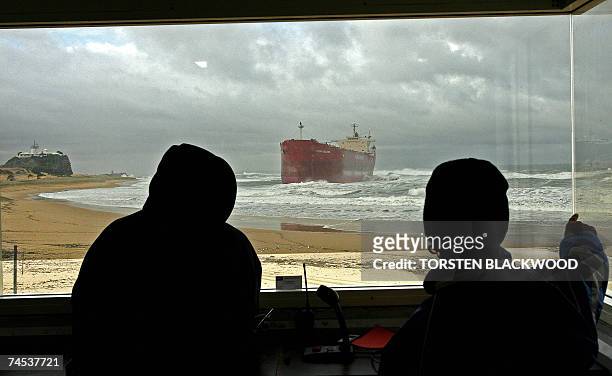Lifeguards watch wild seas pound the 30,000-tonne bulk coal carrier 'Pasha Bulker' which ran aground off Nobbys Beach in Newcastle, north of Sydney,...