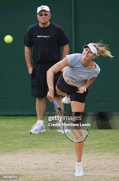 Yuri Sharapova watches as Maria Sharapova of Russia warms up during the DFS Classic at the Edgbaston Priory Club on June 11, 2007 in Birmingham,...